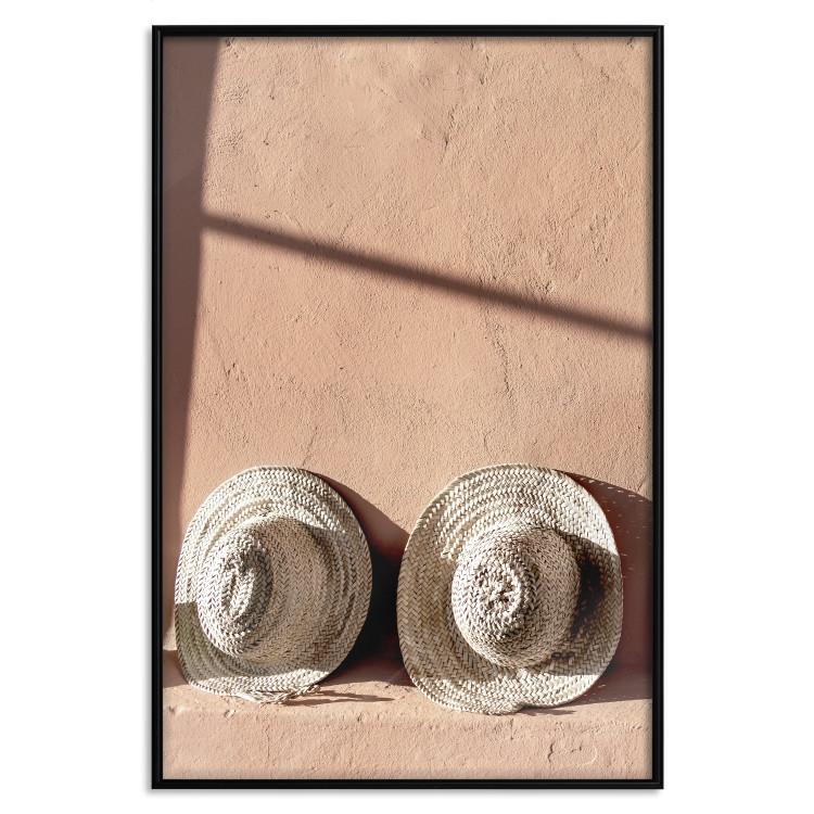 Sonniges Paar - Zwei Hüte im Glanz der Sommer Sonne vor einer Wand